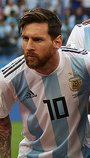 Lionel Messi standing with the Argentina national football team on the pitch